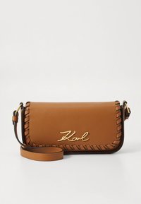 Brown leather clutch bag with braided edges, gold "Karl" logo, detachable shoulder strap, and a smooth texture.