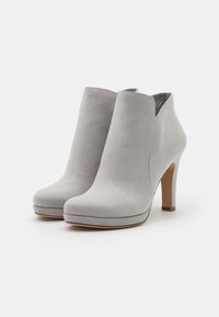 Gray suede ankle boots with a pointed toe, a platform, and a stiletto heel. Smooth texture and minimalistic design.