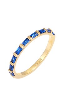 Anillo de tono dorado que presenta piedras azules alargadas dispuestas en un diseño moderno, con una banda suave y una marca grabada "925" en el lado interior.