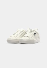 White leather sneakers with a smooth texture, lace-up design, and minimalistic style. Features a black logo tab on the side and a rubber sole.