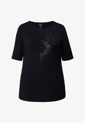 Schwarze, kurzärmelige Damenbluse mit rundem Ausschnitt, vorne rechts mit einer diagonalen Verzierung aus Pailletten und Perlen in Blumenform.