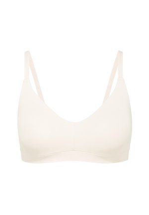 Lichtbeige draadloze beha met dunne verstelbare straps, zachte stof, een glad oppervlak en een ronde halslijn zonder beugel of padding.
