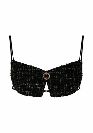 Zwarte cropped bralette van textuurstof met een geruit patroon, verstelbare bandjes en een ronde goudkleurige embellisment in het midden.