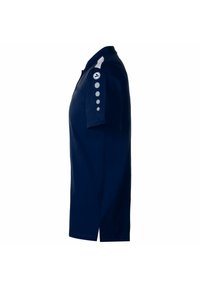 Polo bleu marine en coton, avec un col, des manches courtes et des boutons argentés sur la manche gauche. Détail d fente sur les côtés.