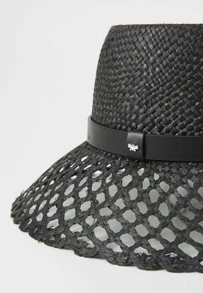 Black woven straw hat with a wide brim, featuring a flat top design and a smooth black leather band with a silver accessory.