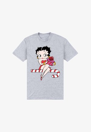 Grå kortærmet t-shirt med en tegneseriefigur med sort hår, rød kjole og en gave på en stribet sukkerrørbaggrund.