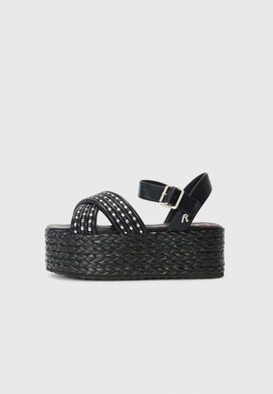 Black platform sandals with braided jute sole, featuring multiple crossed straps, a buckle closure, and silver accents on straps.