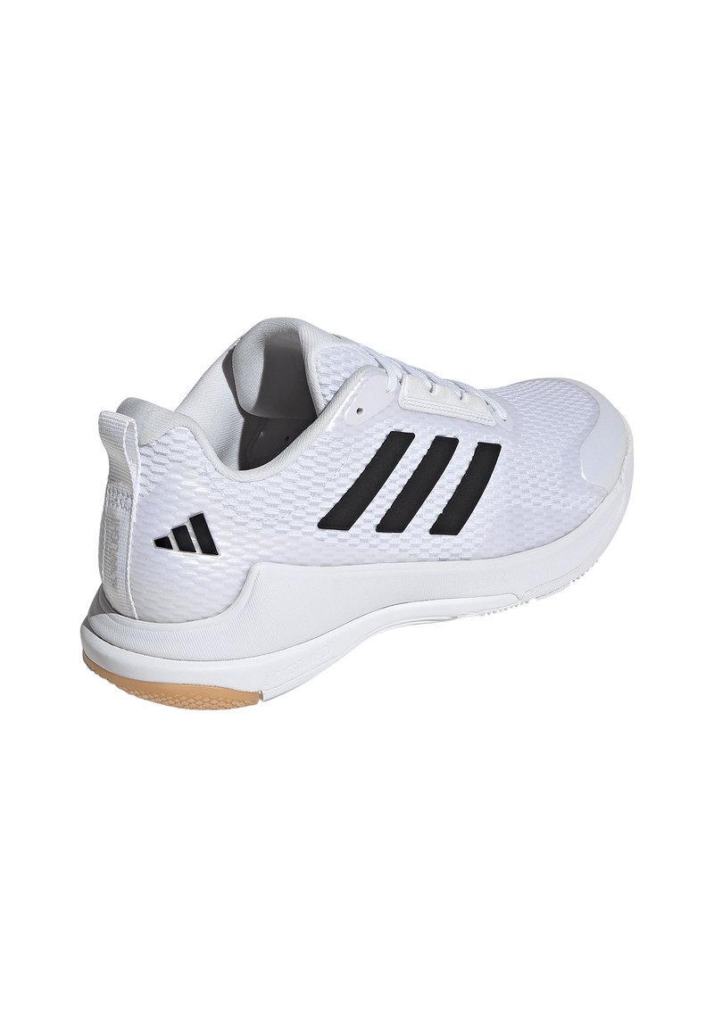 Zapatilla deportiva blanca con parte superior de malla texturizada, rayas negras y suela de goma. Incluye diseño de cordones y talón reforzado.