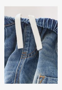 Unselected, mid blue tint denim
