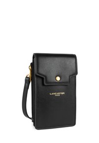 Borsa a tracolla nera in pelle con patta, hardware dorato e logo brandizzato. Caratterizzata da una chiusura con zip e una tracolla removibile. Texture liscia.