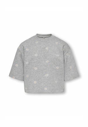 Sweat-shirt gris clair à manches courtes avec des imprimés de marguerites blanches et jaunes dispersées sur le tissu.