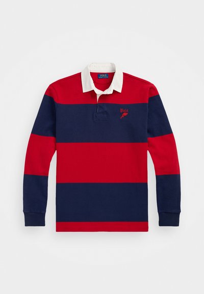 Πολυάρι με μακρύ μανίκι, λευκό γιακά, κόκκινες και ναυτικού χρώματος οριζόντιες ρίγες, κεντητό λογότυπο στο στήθος και ριμπ μανσέτες. Υλικό από βαμβάκι.