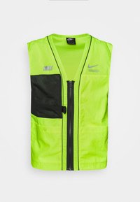 Neon grön ärmlös väst med dragkedja fram, svart meshnäskficka och svarta detaljer. Inkluderar dubbla Nike-loggor på bröstet.