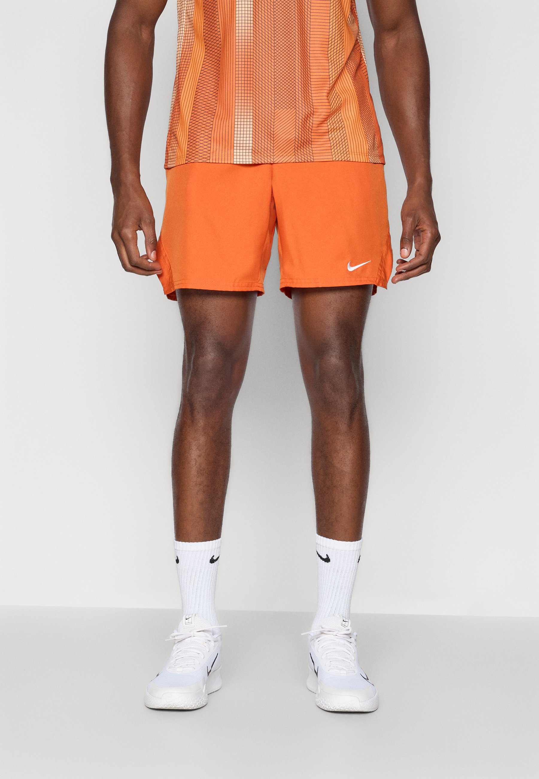 white and orange nike shorts