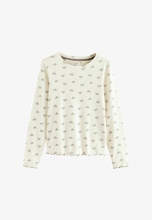 Cremefarbener Langarmtop mit gerippter Textur und einem grauen Schleifenmuster. Runder Ausschnitt und gewellter Saum.