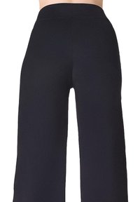 Czarne spodnie z szerokimi nogawkami, wykonane z gładkiego, elastycznego materiału; posiadają wysoki pas i jednolity kolor bez wzorów ani akcentów.