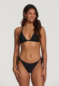 Čierny bikiny set s trojuholníkovým vrcholom a spodným dielom na zaväzovanie. Hladký povrch s minimálnym kovovým uchytením a bez viditeľných vzorov.