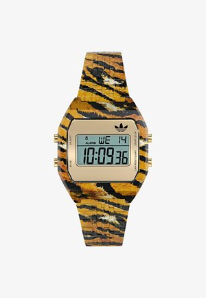Skaitmeninis laikrodis su auksiniu LCD ekranu, geltonos ir juodos spalvų juostos su tigrų dryžių raštu bei auksinėmis aparatūros mygtukais šonuose.
