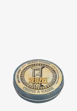 Ronde blik Reuzel scheercrème met guillotine-illustratie en tekst in het Engels en Frans op het deksel.