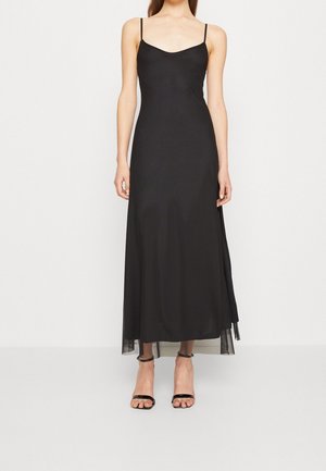 Black spaghetti strap maxi dress with a smooth, satin-like texture and a slightly translucent hem. Features a classic silhouette.