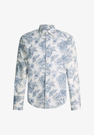 Chemise blanche à manches longues boutonnée avec imprimé floral bleu et feuillage tropical et col pointu.