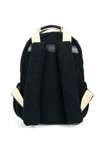 Zaino nero realizzato in materiale plush e texturizzato, con spallacci imbottiti e una maniglia superiore liscia di colore nero. Presenta dettagli in tonalità crema sugli spallacci.