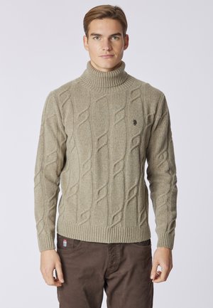 Maglione beige a collo alto in maglia rasata con polsini e orlo a coste. Presenta un motivo testurizzato e un piccolo logo sul petto.