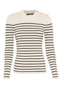 Pull en maille crème à manches longues avec des rayures horizontales noires et trois boutons dorés sur l'épaule gauche.