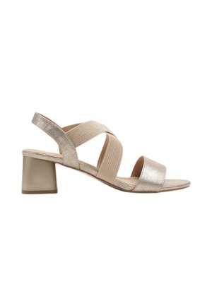 Sandale beige métallisée à bout ouvert avec talon bloc et larges brides élastiques croisées sur le cou-de-pied et la bride arrière.