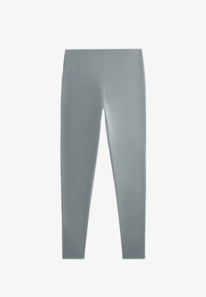 Graue Leggings aus einem glatten, dehnbaren Stoff, mit hohem Bund und schmaler Silhouette, die für Komfort und Bewegungsfreiheit konzipiert sind.