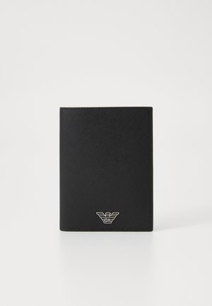 Black wallet made of textured material with a vertical orientation. Features a silver logo emblem at the bottom front. Clean, minimalist design.