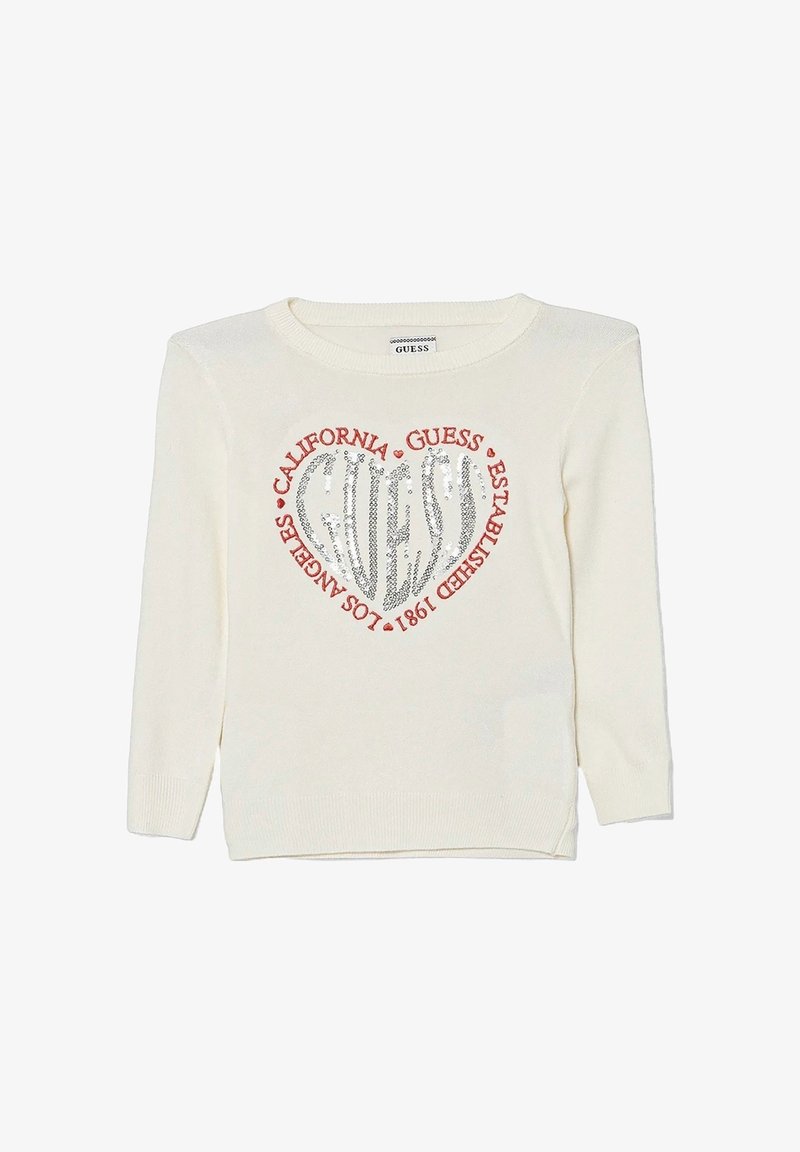 Maglione color crema con collo rotondo, caratterizzato da un design a cuore argentato luccicante al centro e testo rosso attorno ad esso.