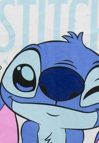 Blue cartoon alien character with large eyes, smiling and winking against a light blue and white background with partial text.