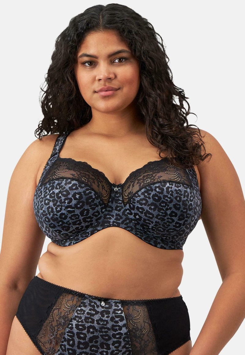 Mustikan ja sinisen leopardikuosiset alusvaatteet, joissa on pitsireunuksilla varustettu pehmeäkuppinen rintsikka ja vastaavat korkeat alushousut pitsikoristeilla.