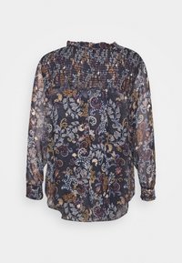 Blusa nera trasparente con motivi floreali in rosso, blu e giallo. Presenta un colletto arricciato e maniche lunghe a sbuffo.