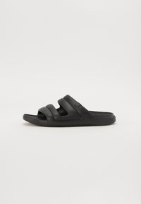 Chausson noir en caoutchouc texturé avec trois larges bandes et une semelle intérieure profilée, dotée d'un design à bout ouvert et d'un détail de logo.