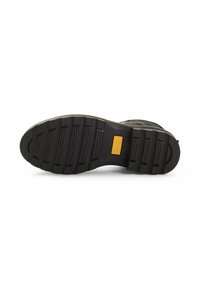 Semelle de botte noire avec des rainures texturées, dotée d'un accent de marque jaune. Le matériau semble en caoutchouc et durable, adapté à une utilisation en extérieur.