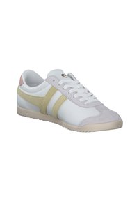 White sneaker with light gray and pale yellow suede stripes. Features a textured cream rubber sole and white laces. Subtle branding on the tongue.