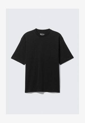 T-shirt nero a maniche corte in cotone con scollatura rotonda, caratterizzato da una vestibilità rilassata e un design minimalista. Senza motivi né accenti.