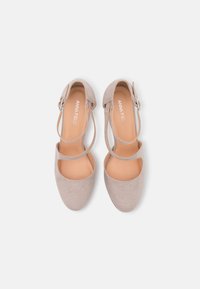 Beige suede high-heeled shoes with a rounded toe, dual ankle straps, and an exposed side. Smooth interior and a slight platform sole.