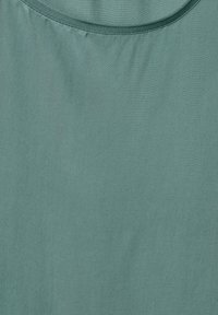 Lightweight, teal fabric with a smooth texture and a round neckline. The material appears soft and is wrinkle-resistant.