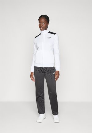 White zip-up jacket with black accents, paired with gray pants. Both feature a logo. The fabrics appear smooth and activewear style.