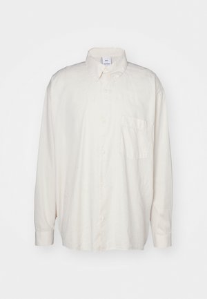 Lichtbeige overhemd met knopen van katoen, met een klassieke kraag, lange mouwen en een enkele borstzak. Gladde textuur.