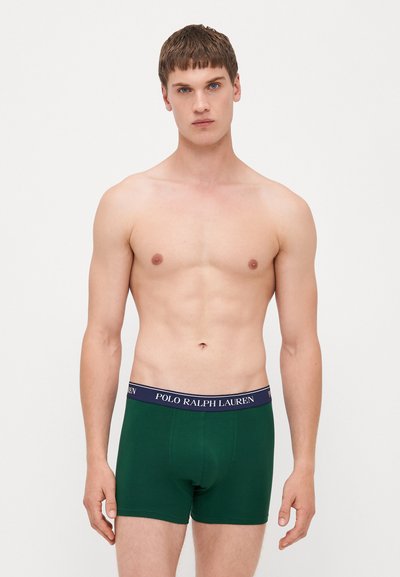 Zelene bombažne bokserice z navy elastičnim pasom, na katerem je napis "POLO RALPH LAUREN" v beli barvi. Gladka tekstura in prilegajoča zasnova.