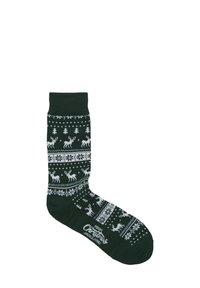 Groene gebreide sok met witte patronen van rendieren, bomen en sneeuwvlokken; bevat de tekst "Vrolijk Kerstfeest" en het merklogo op de teen.