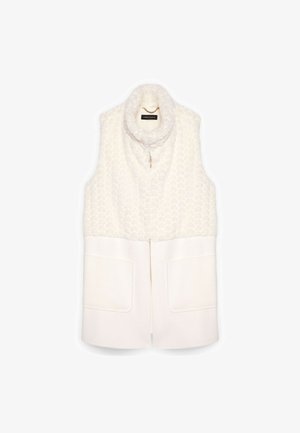 Gepolsterte ärmellose Weste in Creme, mit einer strukturierten Oberseite und einem glatten unteren Bereich, zwei Fronttaschen und einem hohen Kragen.