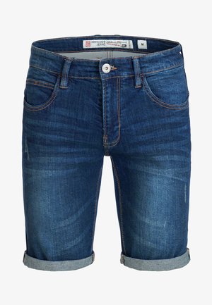 Džínové šortky v tmavomodrej farbe s vyblednutým povrchom. Vybavené ohnutým lemom, dizajnom s piatimi vreckami a kontrastným oranžovým šitím. Veľkosť: M.