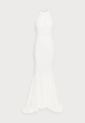 White lace dress with a fitted bodice and halter neckline, featuring floral patterns and a flowing skirt that flares out at the hem.