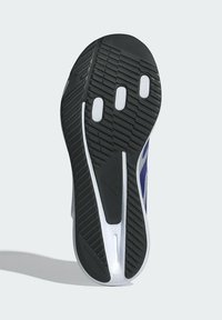 Black rubber outsole with textured grip patterns and white accents. Features three white openings and a sleek blue and silver side design.