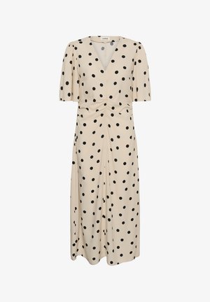 Robe midi crème à pois noirs, manches courtes bouffantes, décolleté en V, et détail froncé à la taille.